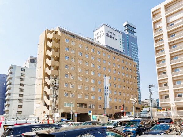 A multi-story hotel with a uniform facade, numerous windows, and a prominent vertical sign. - Toyoko Inn Sendai Nishi Hirose Dori (Sendai)