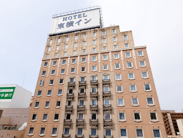 A multi-story hotel building with a sign indicating it is a hotel.