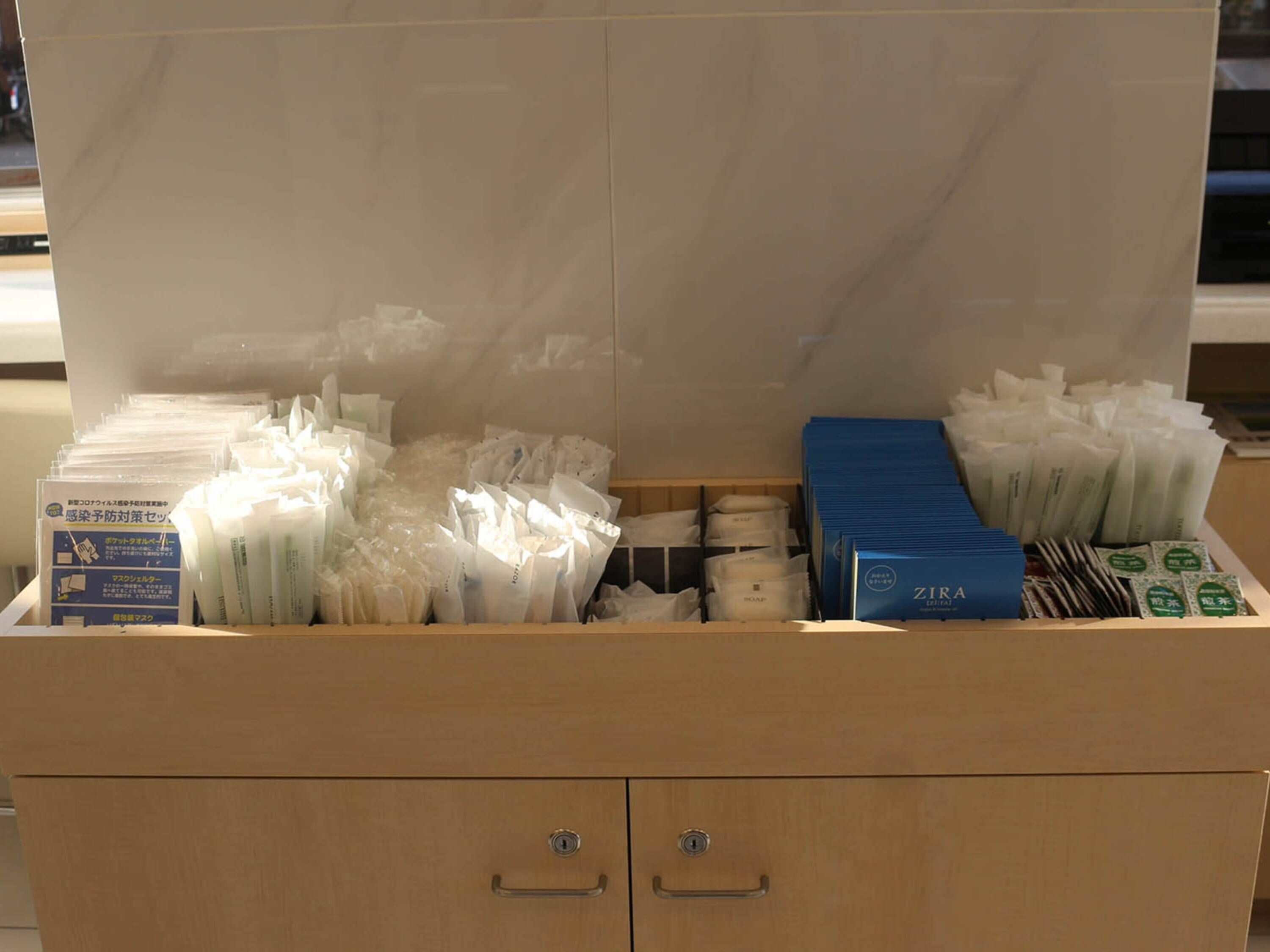 A storage area with various items including boxes and packages, likely containing toiletries or supplies.