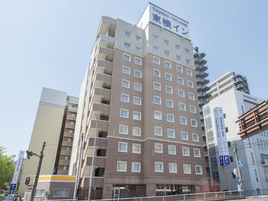 A multi-story hotel with a prominent signage for 'toyoko inn'.