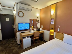 A hotel room with a bed, desk, chair, air conditioning unit, and a television. - Toyoko Inn Shin Yokohama Station Honkan (Yokohama)