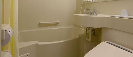 A bathroom with a bathtub, toilet, and sink.