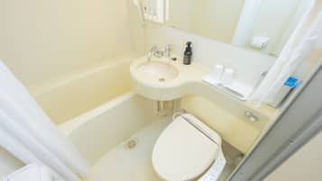 A small bathroom with a sink, toilet, and a mirror above the sink.