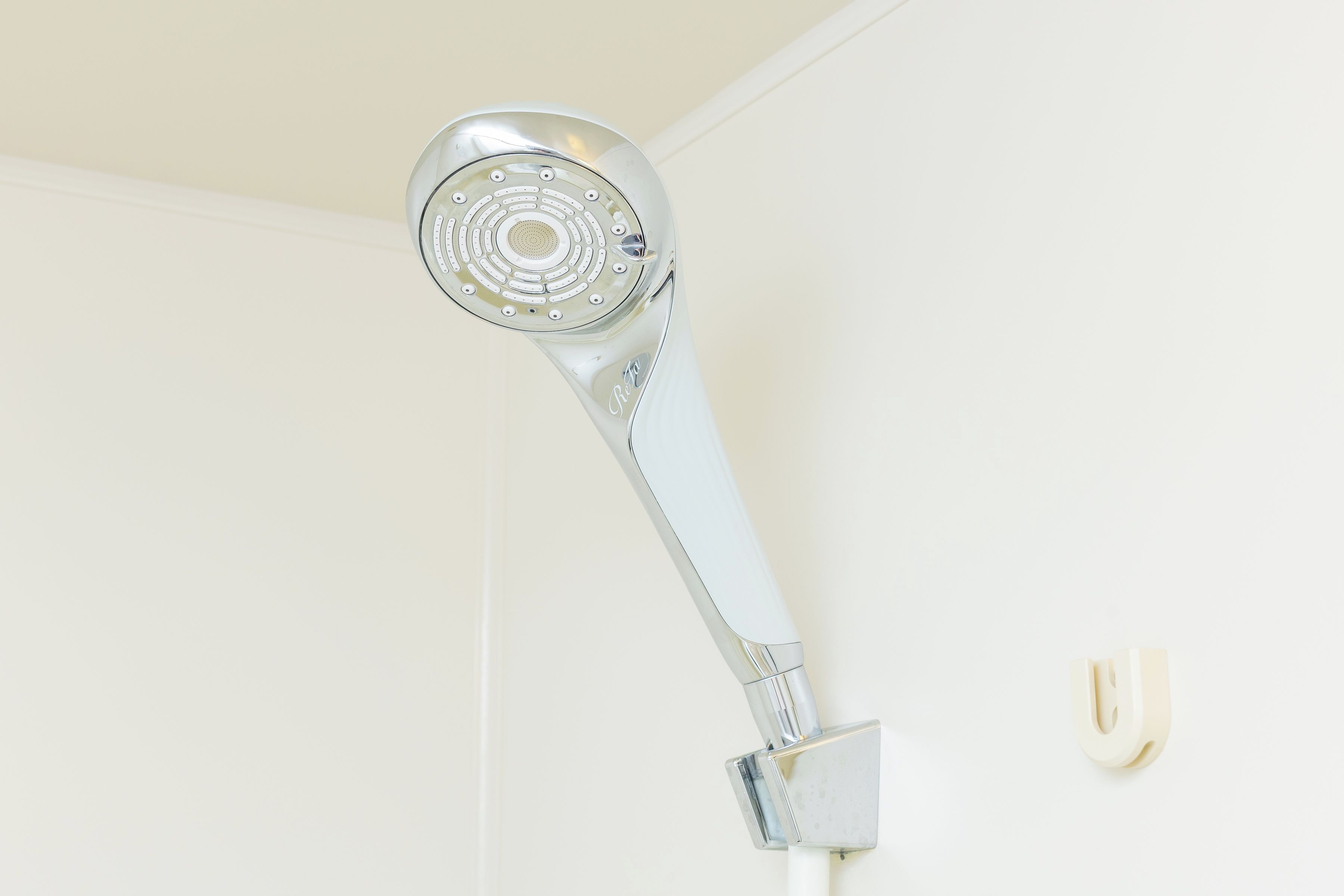 A showerhead mounted on a wall.