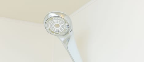 A showerhead mounted on a wall.