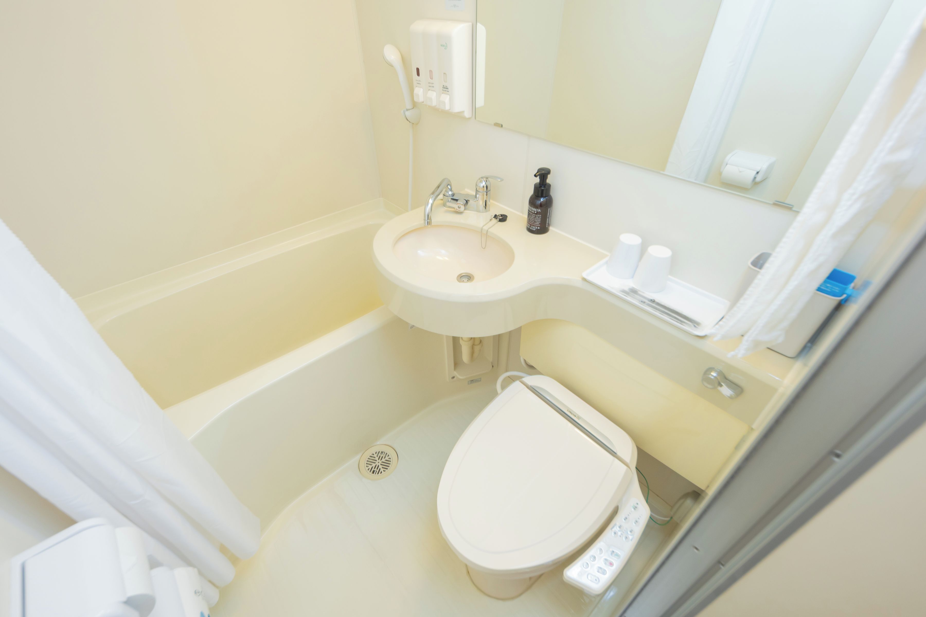 A small bathroom with a sink, toilet, and a mirror above the sink.