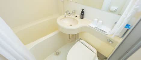 A small bathroom with a sink, toilet, and a mirror above the sink.