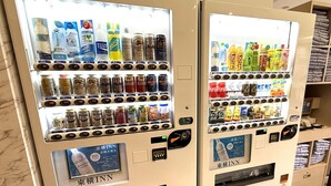 Two vending machines with various beverages and snacks, including water, sodas, and cans. - Toyoko Inn Okinawa Naha Kokusai Dori Miebashi Station (Naha)