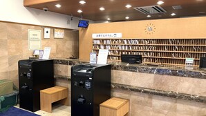 A reception area with a marble counter, wooden shelves, a clock, and a security camera. - Toyoko Inn Sendai Station Nishi Chuo (Sendai)