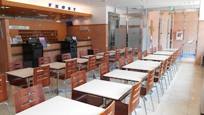 A cafeteria with long tables and chairs, a vending machine, and a sign that reads "FRONT". - Toyoko Inn Tokushima Station Bizan (Tokushima)