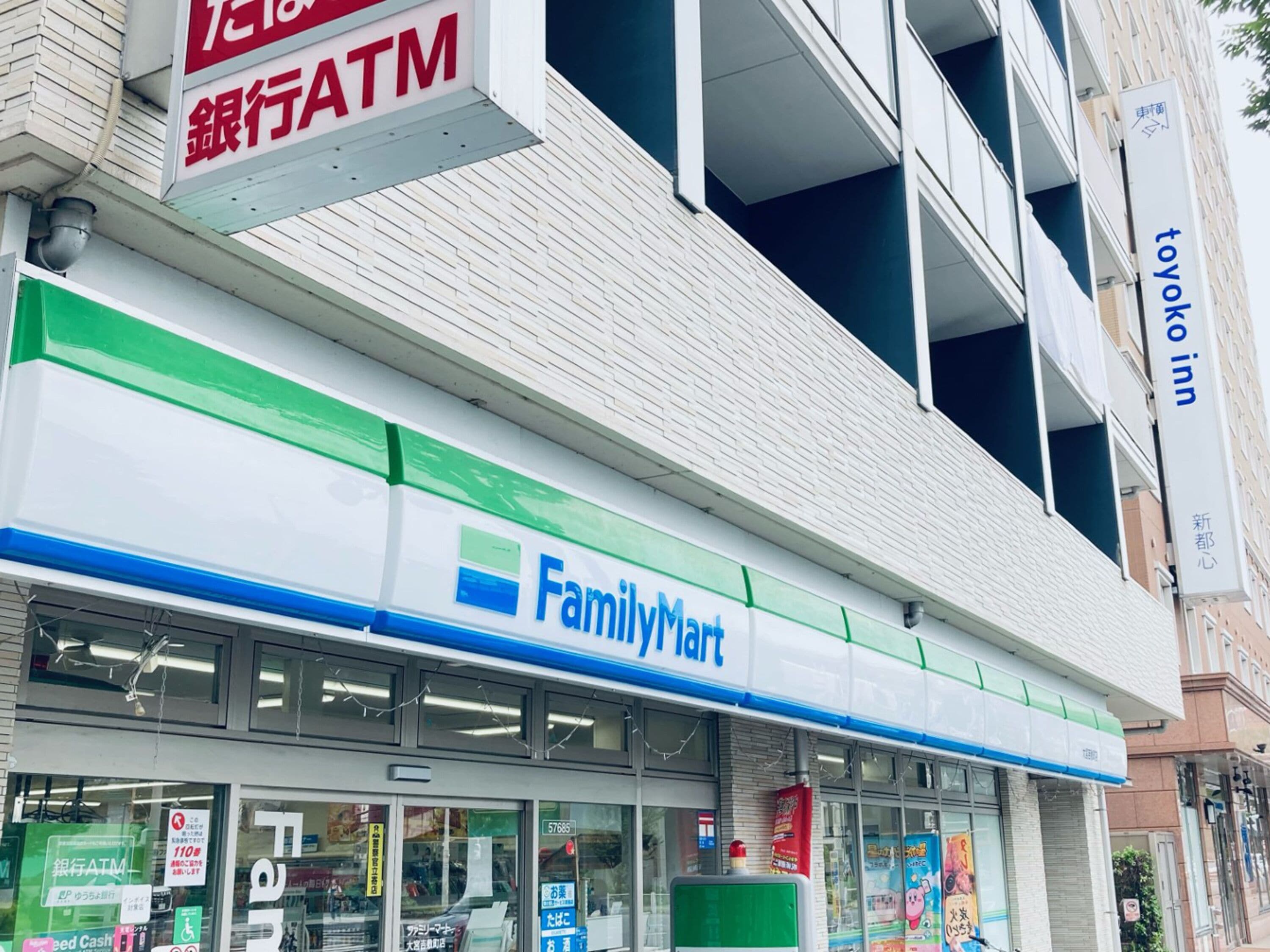 A FamilyMart store with a visible ATM sign above the entrance.