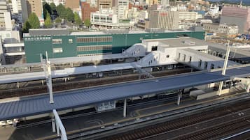 A train station with multiple platforms and tracks, surrounded by urban buildings.