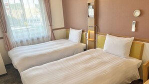 A hotel room with two single beds, a window with curtains, a thermostat, and a bedside table. - Toyoko Inn Tokuyama Station Shinkansen (Shunan)
