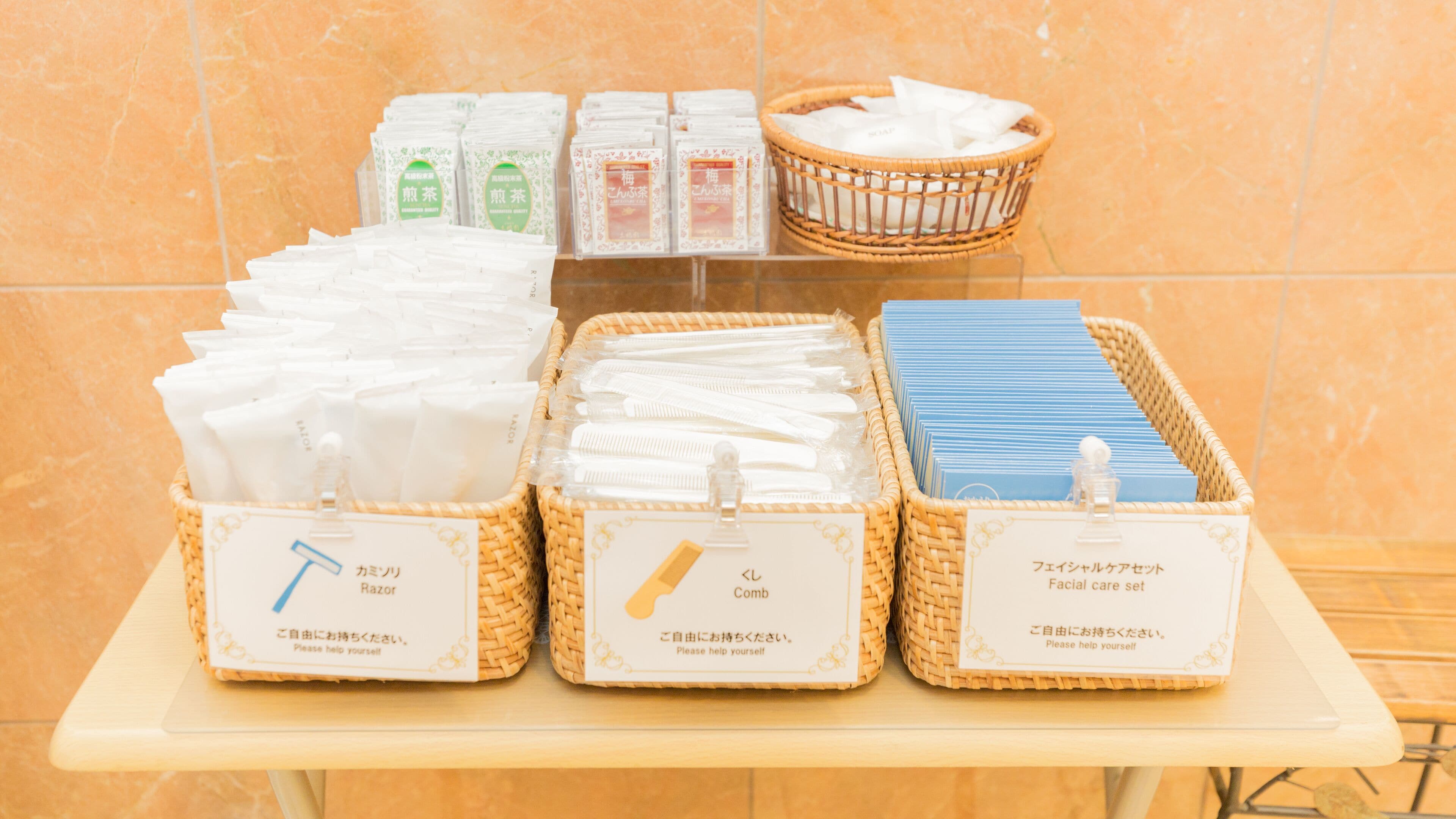 Una mesa con tres cestas que indican 'Navaja', 'Peine' y 'Set de cuidado facial'.