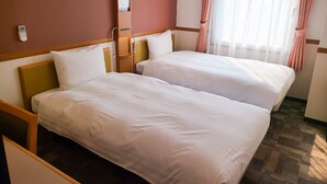A hotel room with two beds, a bedside table, a lamp, a window with curtains, and a remote control on the wall. - Toyoko Inn Fujisan Numazu Station Kita 1 (Numazu)