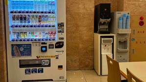 A vending machine with various drink options and a water dispenser.