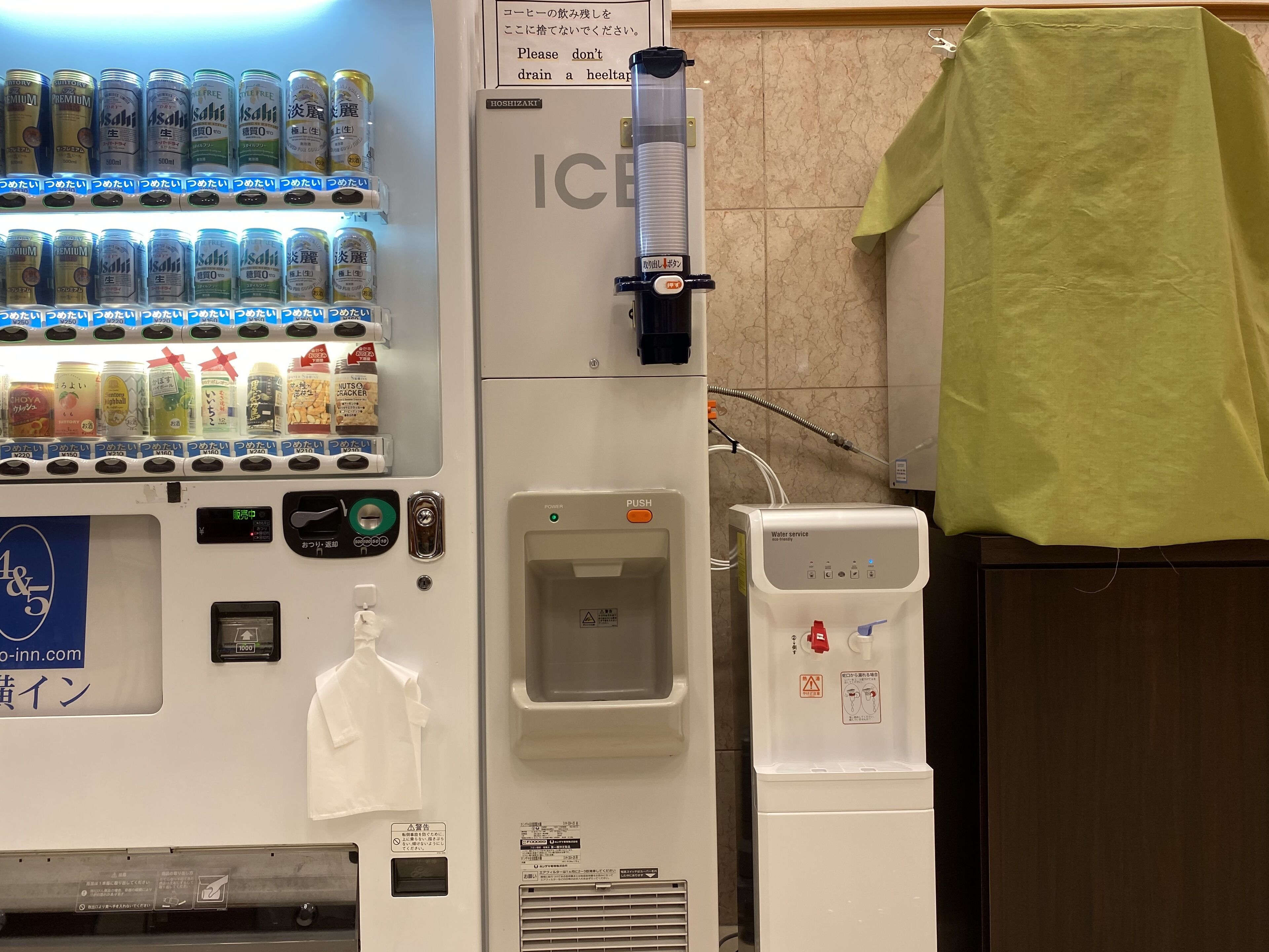 A vending machine with beverages and snacks, an ice dispenser, and a water service unit.