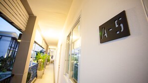 A corridor with a sign indicating room number A-5. - The Loft Room Ubon (Ubon Ratchathani)