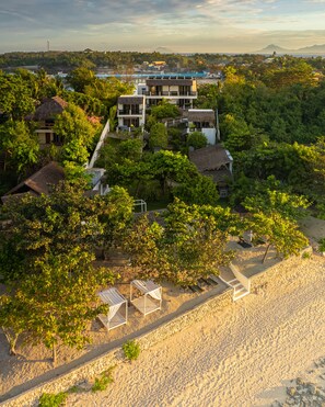 En la playa, sillas reclinables de playa, sombrillas, toallas de playa