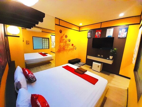 A hotel room with two beds, a TV, a small table, and a wall-mounted shelf. - Honey Inn (Lam Luk Ka)