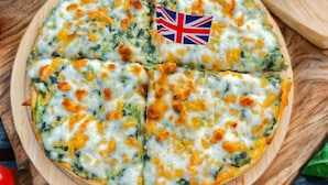 A pizza on a wooden board with a flag. - Honey Inn (Lam Luk Ka)