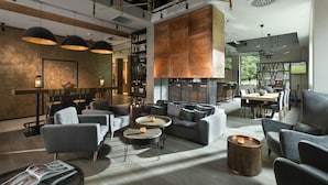 A modern lounge area with sofas, tables, and a fireplace. - Hotel Sopot (Sopot)