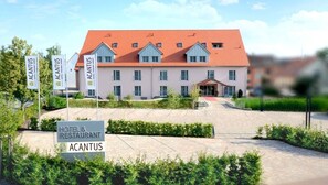 A hotel with a red roof and multiple windows, surrounded by greenery and a paved entrance area. - ACANTUS Hotel (Weisendorf)