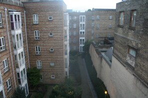 A multi-story residential building with a narrow alleyway between the structures. - Jervis Place Apartment (Dublin)