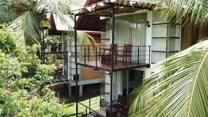 A multi-level wooden structure with a balcony, surrounded by lush greenery. - Eliyanth Udawalawe (Udawalawa)