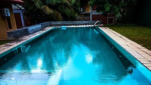 A rectangular swimming pool with a tiled edge, surrounded by a paved walkway. - Eliyanth Udawalawe (Udawalawa)