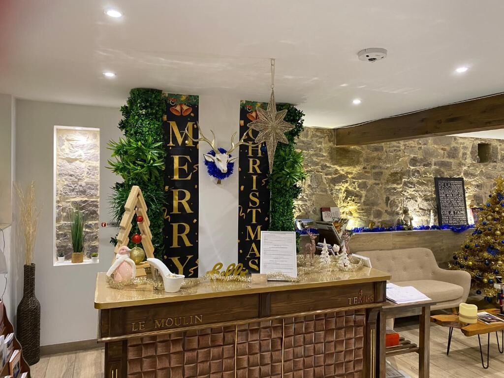A reception area with a Christmas-themed backdrop, a reception desk, and a Christmas tree.