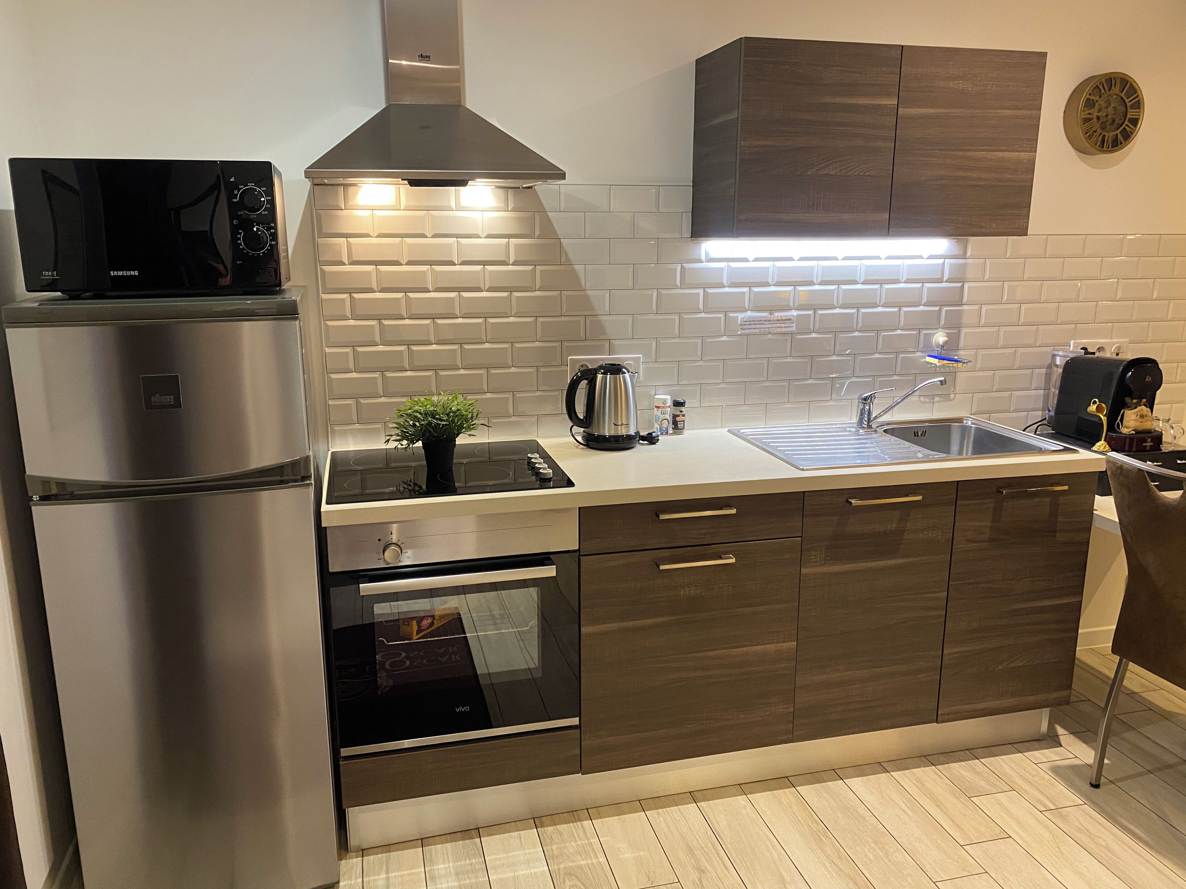 A modern kitchen with a built-in microwave, stove, oven, and a sink.