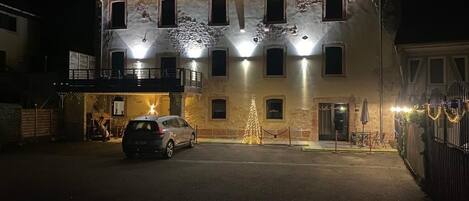 A building with multiple windows and a car parked in front.