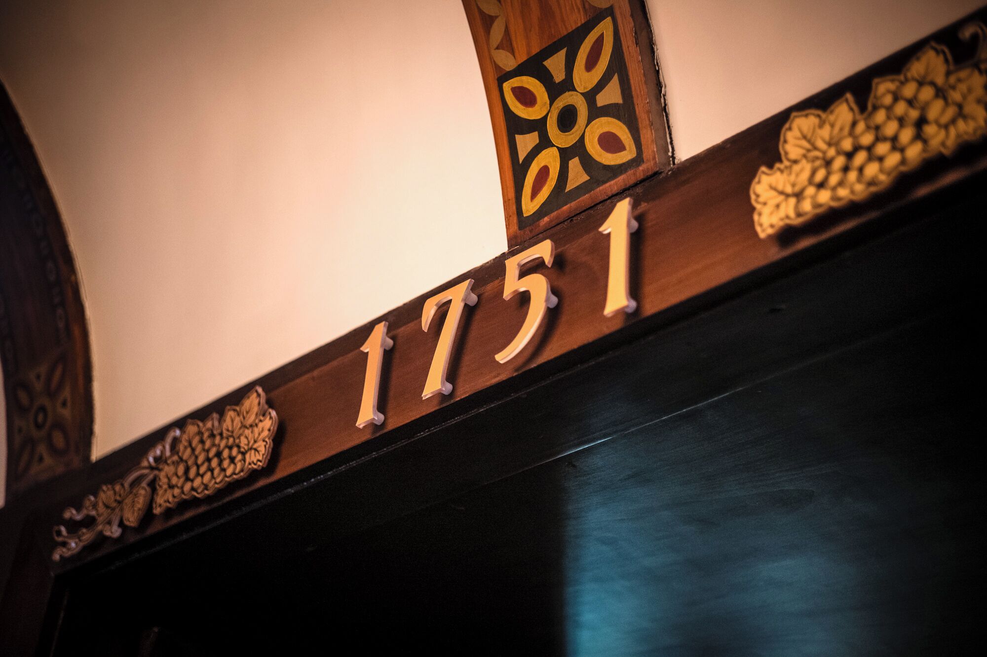 Un letrero de madera con el número 1751, integrado a la estructura de un edificio.