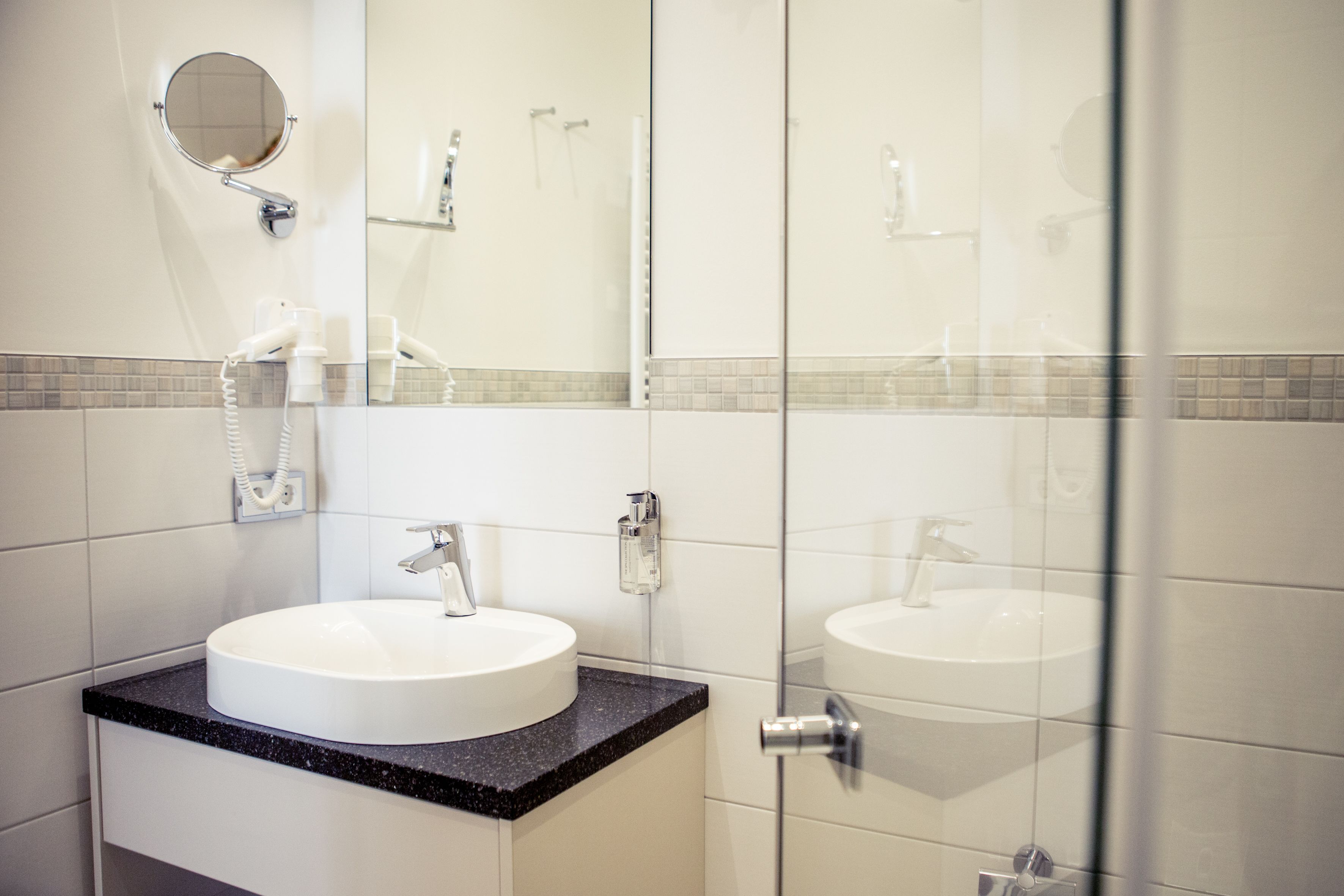 shower, designer toiletries, hair dryer, slippers