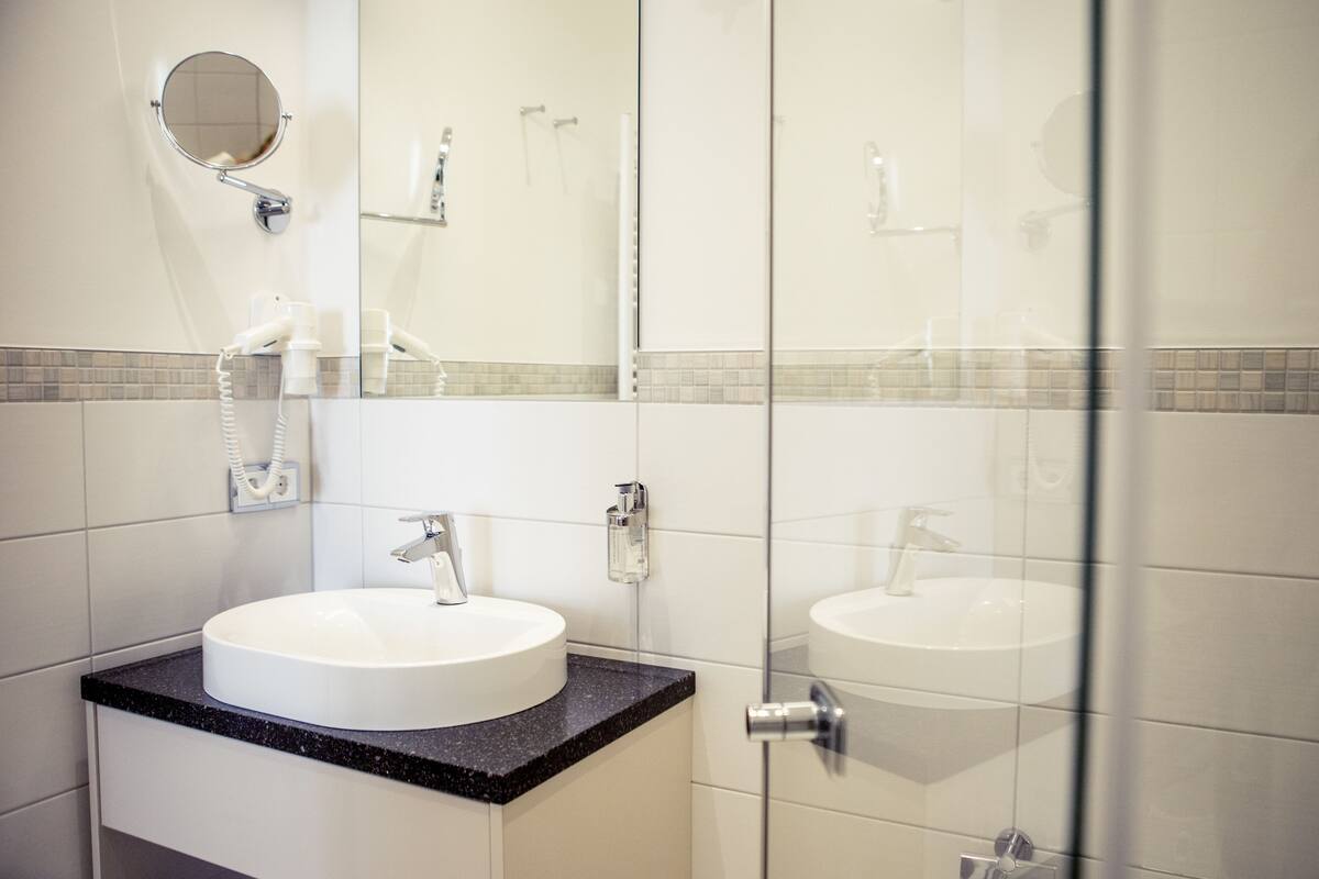 shower, designer toiletries, hair dryer, slippers