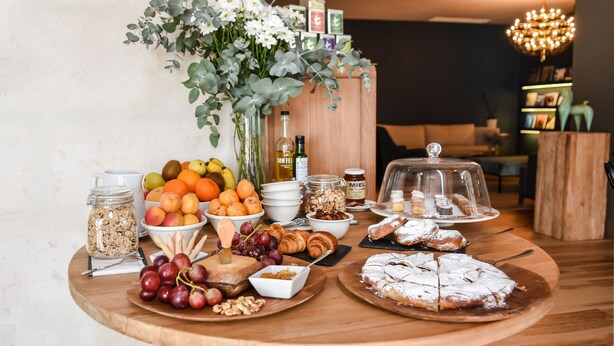 A breakfast buffet with fruits, pastries, and beverages. -  Bordoy Casa Ládico - Hotel Boutique Adults Only (Mahón)