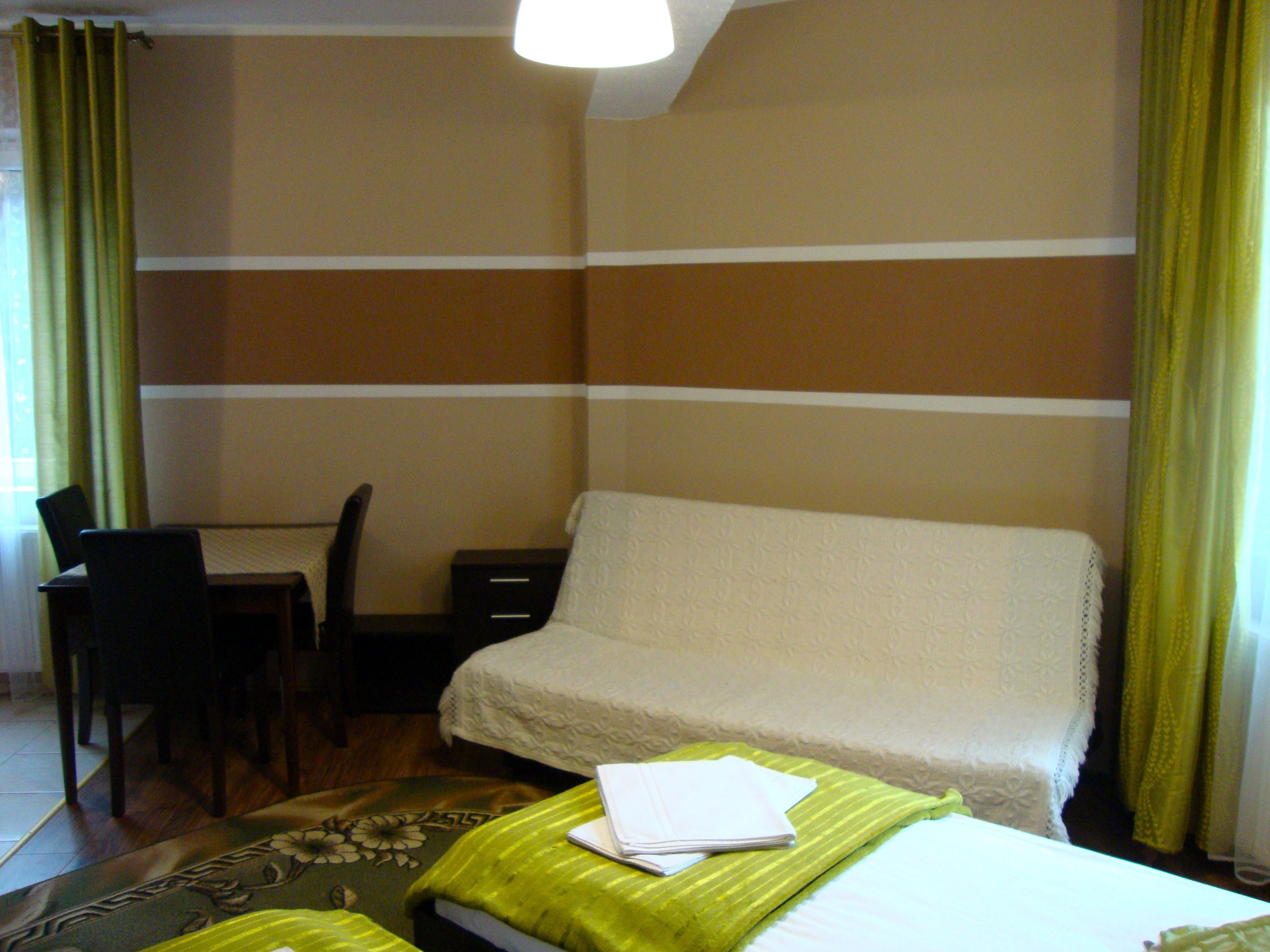 A hotel room with a bed, a desk, and a chair.