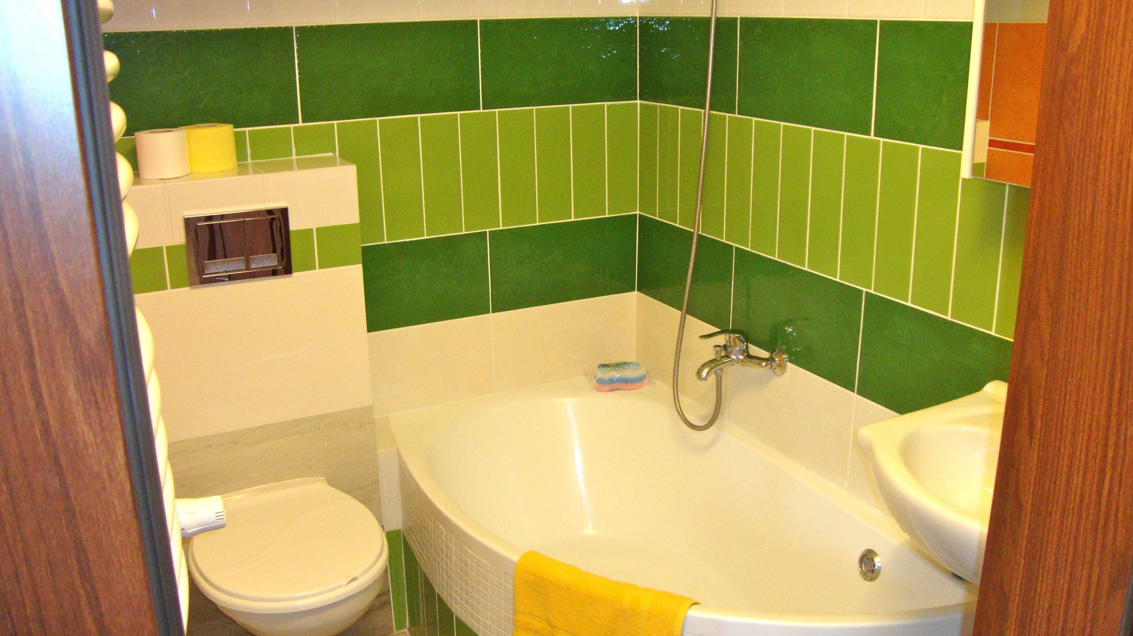 A bathroom with a bathtub, a toilet, and a sink.