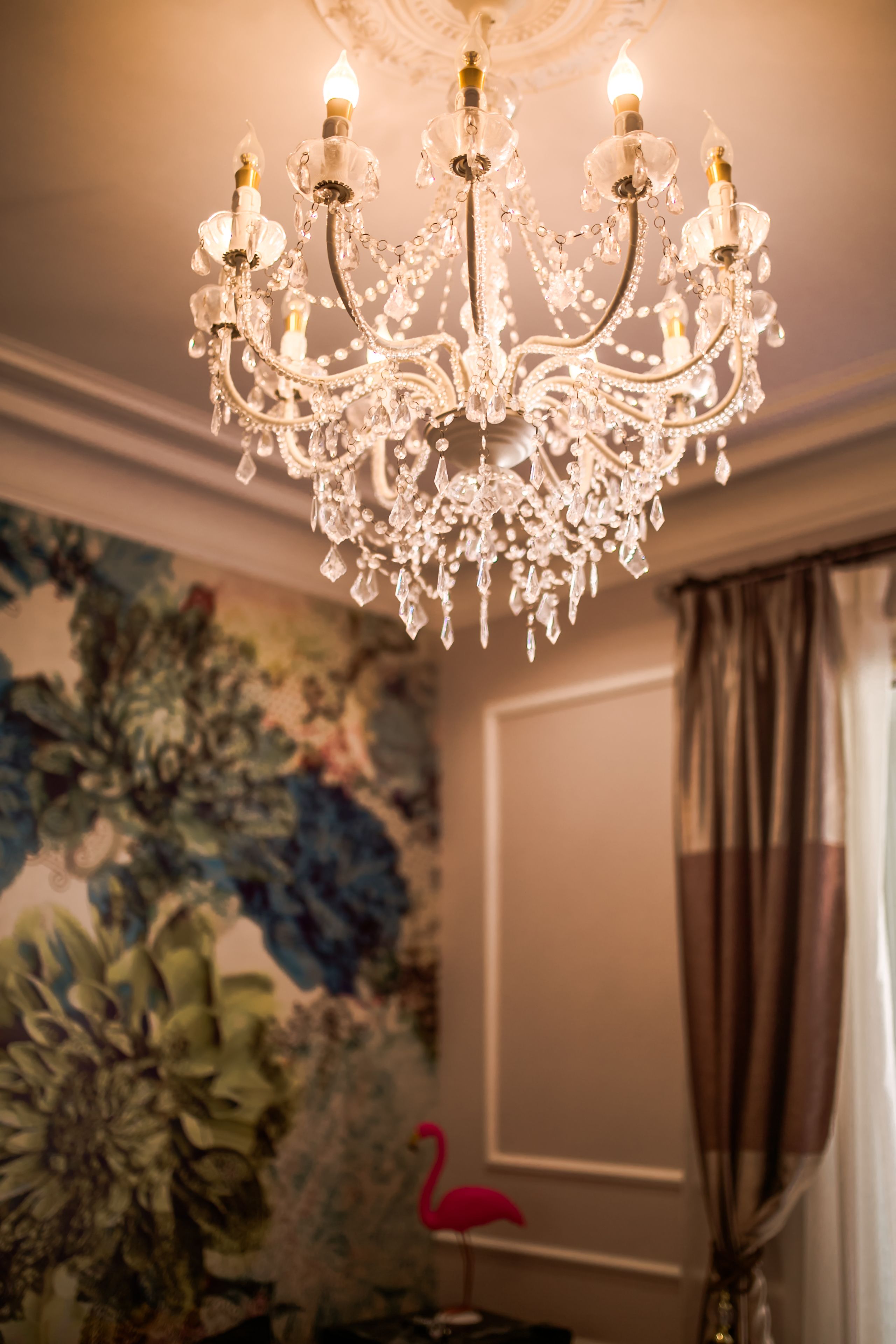 A chandelier with multiple arms and crystal decorations.