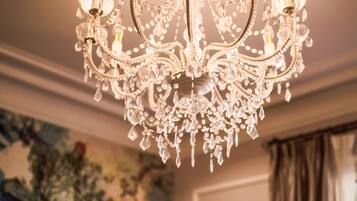 A chandelier with multiple arms and crystal decorations.
