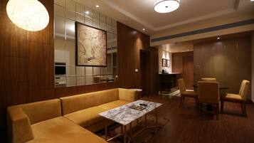 A modern hotel lobby with a sofa, a table, and chairs.