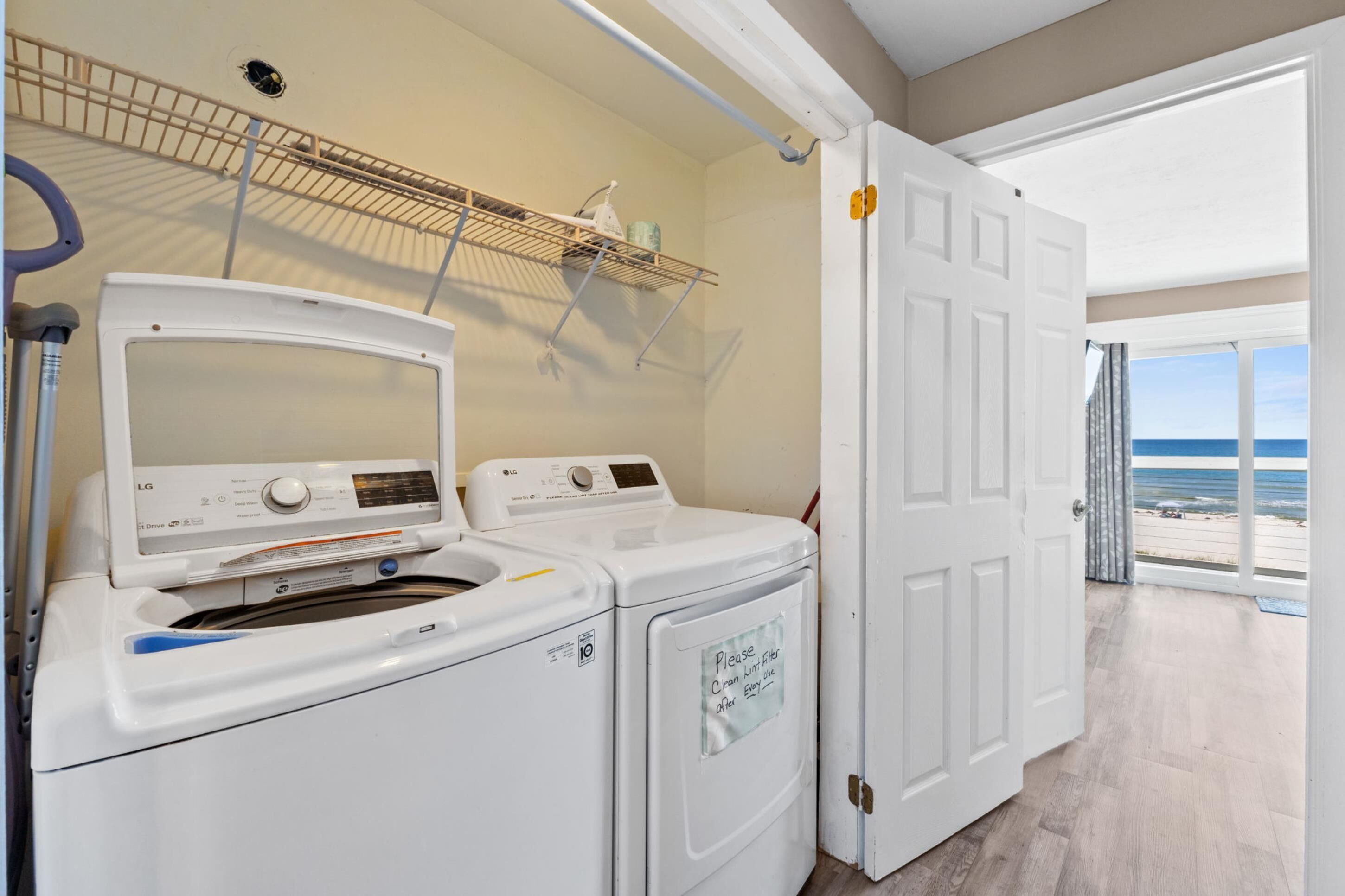 A laundry area with a washing machine, dryer, and a note on the dryer door.
