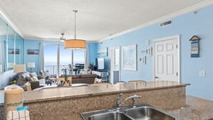 A modern kitchen with granite countertops, stainless steel sinks, and a ceiling fan. - Twin Palms Resort by Panhandle Getaways (Panama City Beach)