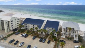 A beachfront hotel with multiple buildings, a parking lot, and a view of the ocean. - Eastern Shores on 30A by Panhandle Getaways (Santa Rosa Beach)