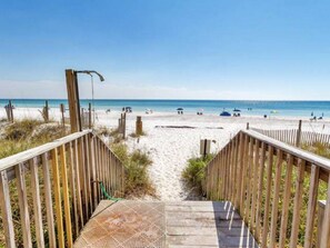 A wooden boardwalk leading to a sandy beach with a clear view of the ocean. - Eastern Shores on 30A by Panhandle Getaways (Santa Rosa Beach)