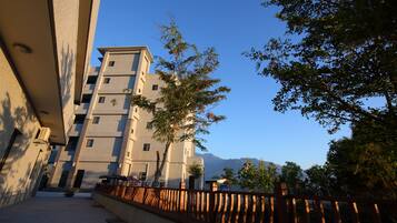 A multi-story building with a modern architectural style, featuring balconies and a courtyard.
