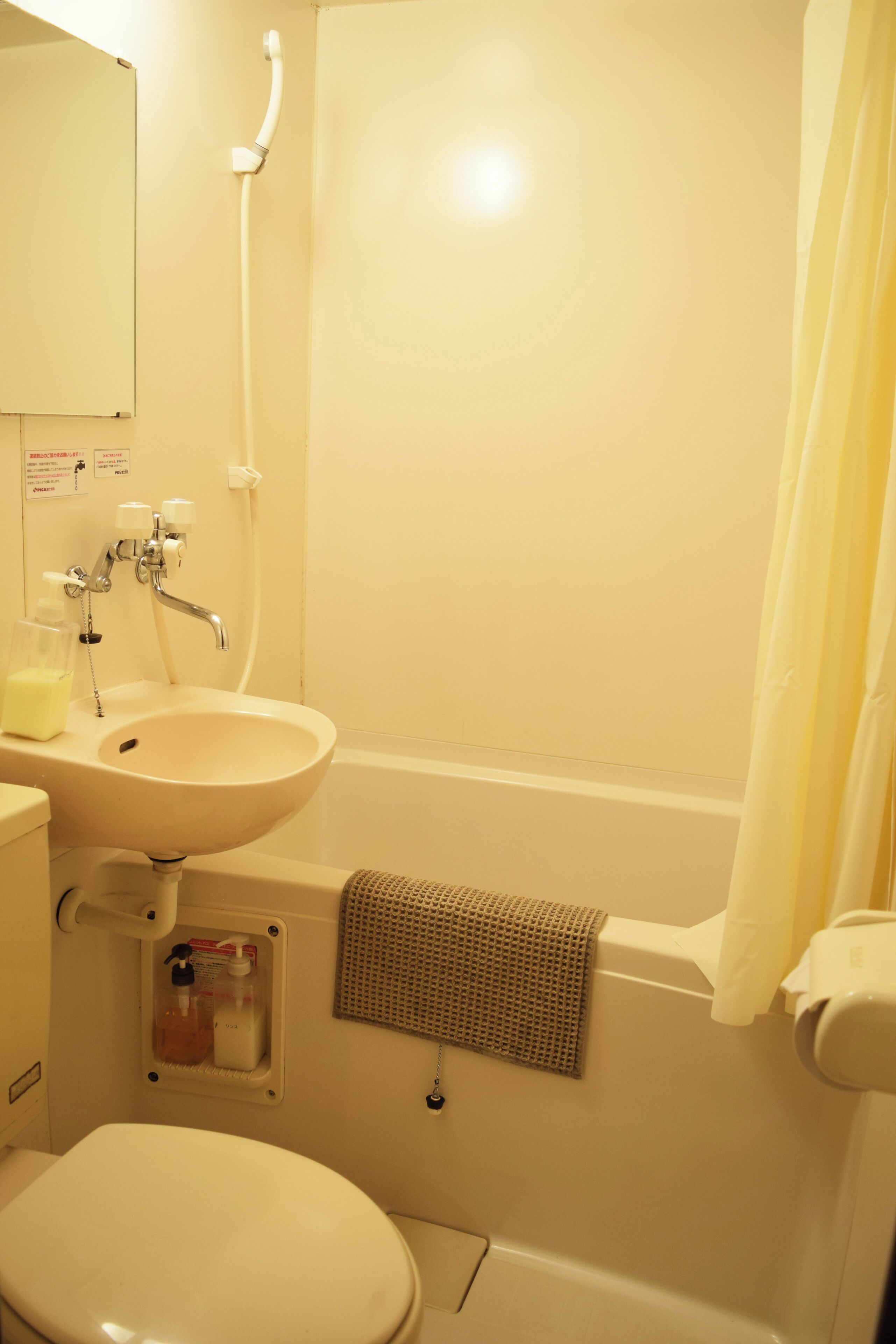 A bathroom with a sink, toilet, and bathtub.