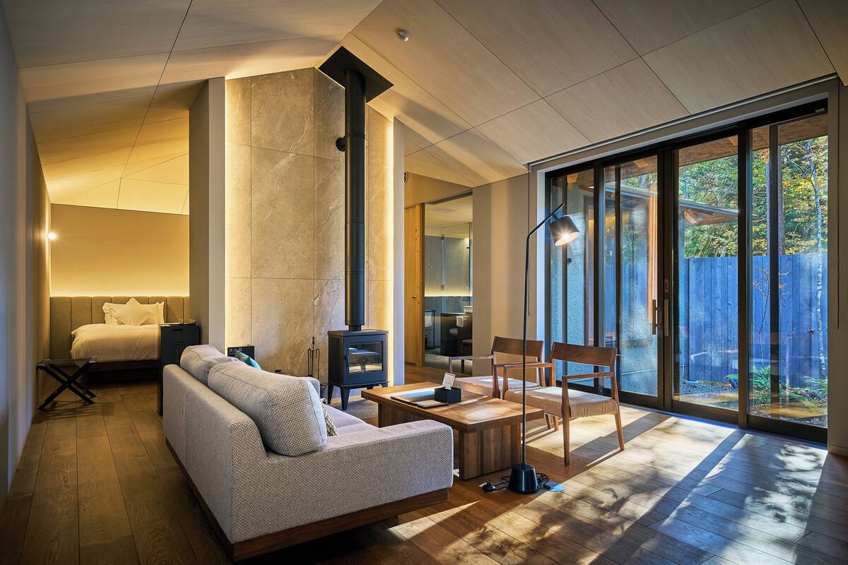 Un salon moderne avec un canapé, une table basse et une cheminée.