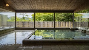A wooden ceiling, a large window, and a pool.